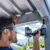 Čovjek koristi Bosch GDS18V-450P aku udarni odvijač za pričvršćivanje metalne konstrukcije.